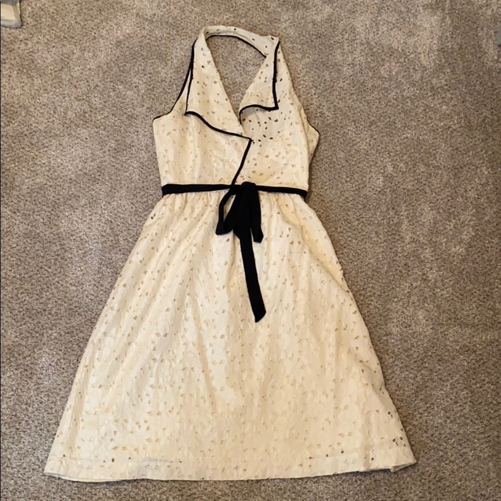 Cream eyelet halter dress with black details.